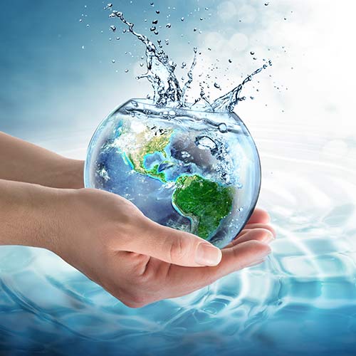 hands holding bowl of water containing planet earth